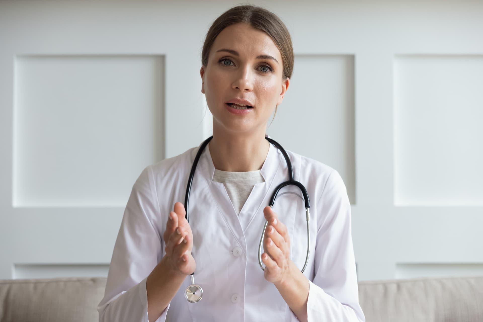 A doctor speaking to camera as she records a short video answer for her practice